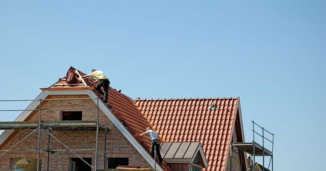contractors repairing roof