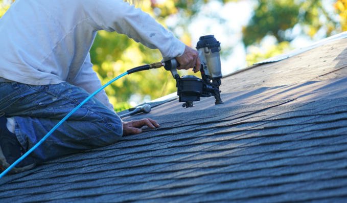 Handyman,Using,Nail,Gun,To,Install,Shingle,To,Repair,Roof